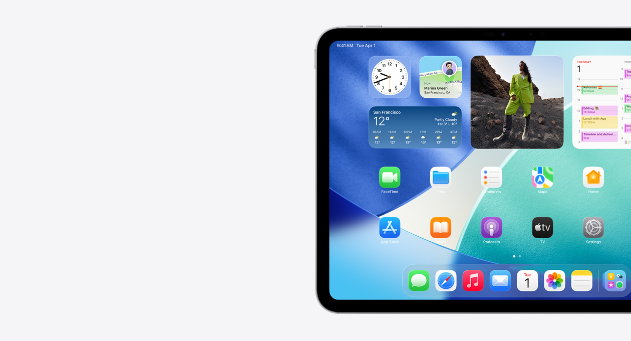 iPad, landscape orientation, left side of screen only, Home Screen with stacked widgets including translucent clock showing Liquid Glass effect, Reminders app, Weather widget, two rows of smaller apps, and the dock