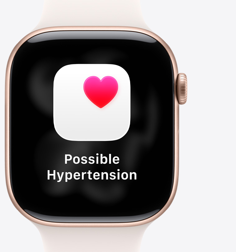 Apple Watch Series 11, titanium case, polished gold color, possible hypertension notification, pink heart in white box, right side exterior, Digital Crown, light blush Sport Band