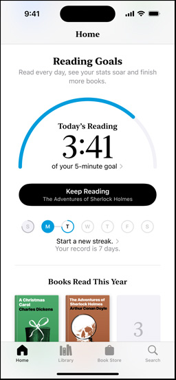 iPhone screen showing the Reading Goals interface in the Books app. At the top, there is a progress ring. Below the progress ring is the weekly reading streak tracker. At the bottom is the Books Read This Year section, which includes a row of two books, with an empty slot for a third