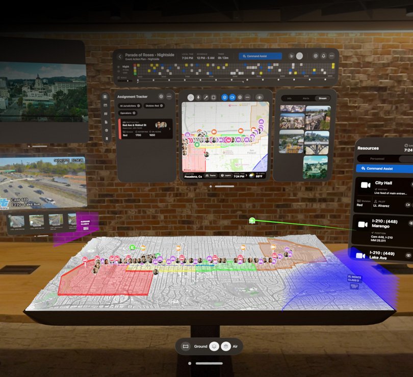 Multiple digital dashboards float with aerial views of Pasadena, California, a 3D map of the city, live video feeds and resourcing plans