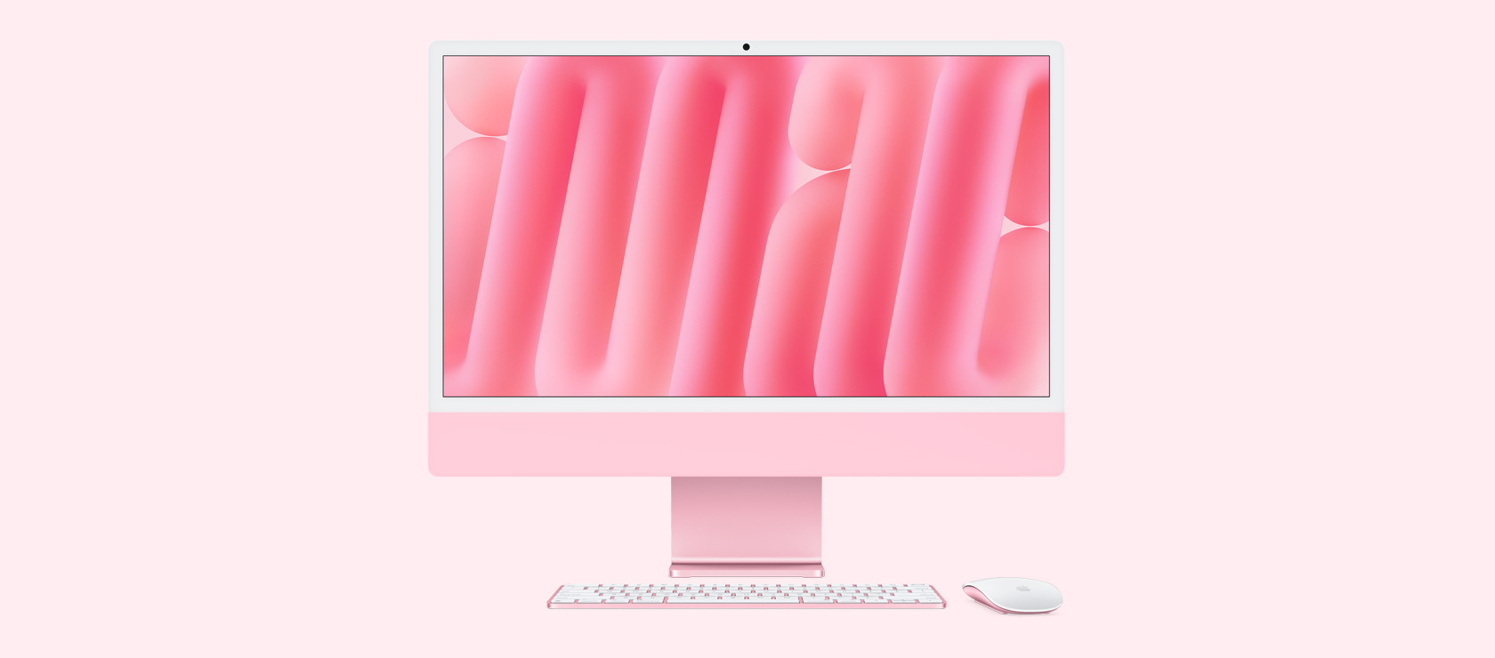 Vista frontal de un iMac rosado con mouse y teclado a juego