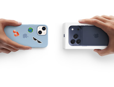 Hands exchanging trade-in iPhone 13 with silicone case, stickers on back exterior, for new iPhone 17 Pro in the box.