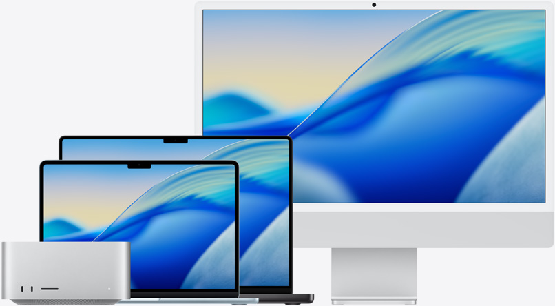 Das macOS Tahoe Hintergrundbild der gesamten Mac Modellfamilie von links nach rechts: Mac Studio, 13" MacBook Air in Himmelblau, 14" MacBook Pro in Space Schwarz und 24" iMac in Silber