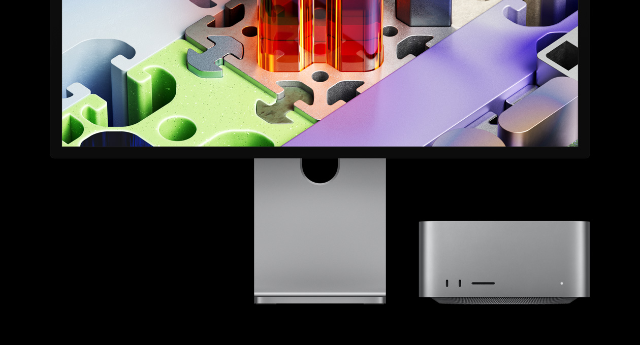 Mac Studio spárovaný s displejom Studio Display XDR, zariadenie je zasunuté pod displejom, na displeji Studio Display XDR sa zobrazuje pozadie v štýle trojrozmerného puzzle