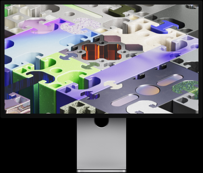 Pohľad spredu na Studio Display XDR s pozadím v štýle trojrozmerného puzzle